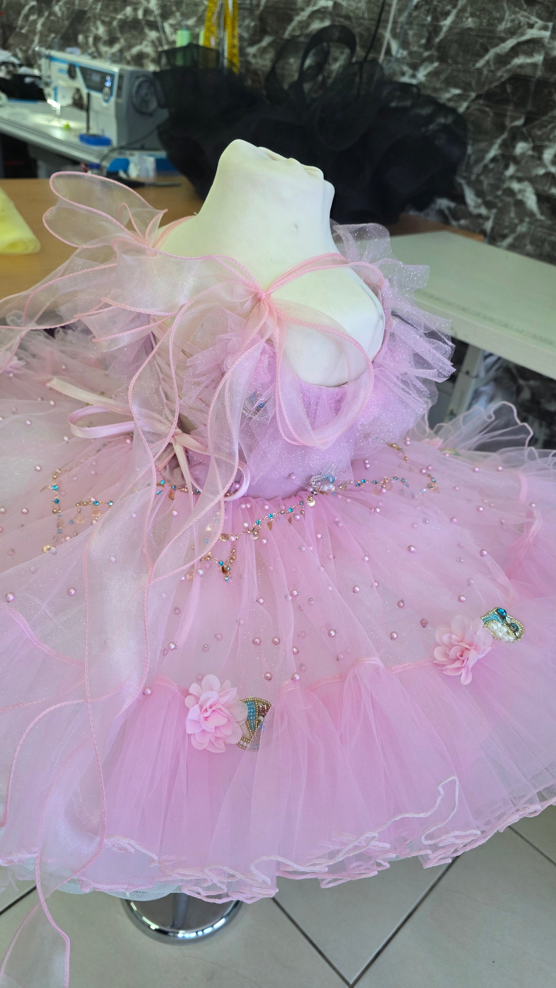 pink and white girls dress on a manequin