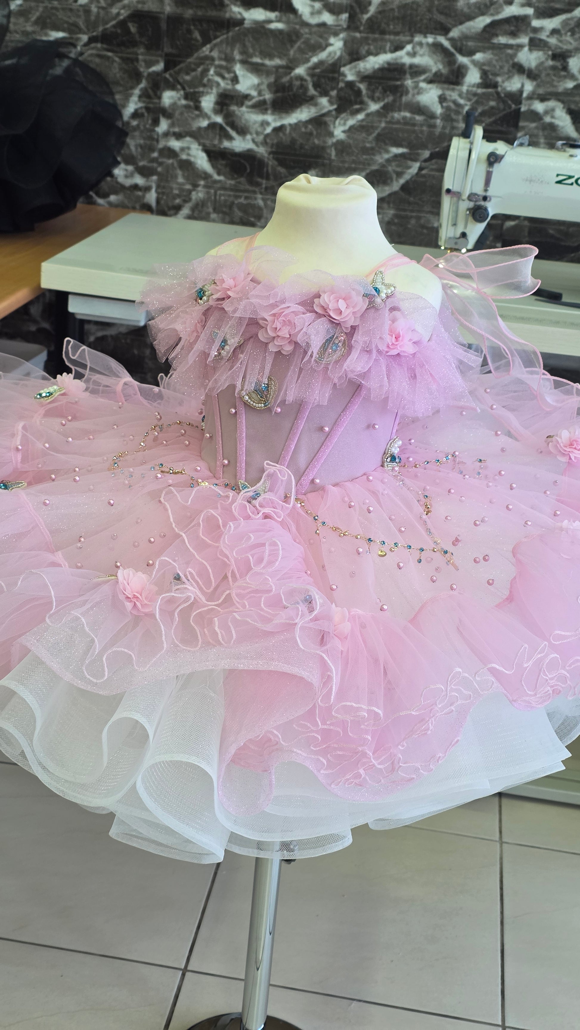 pink and white girls dress on a manequin
