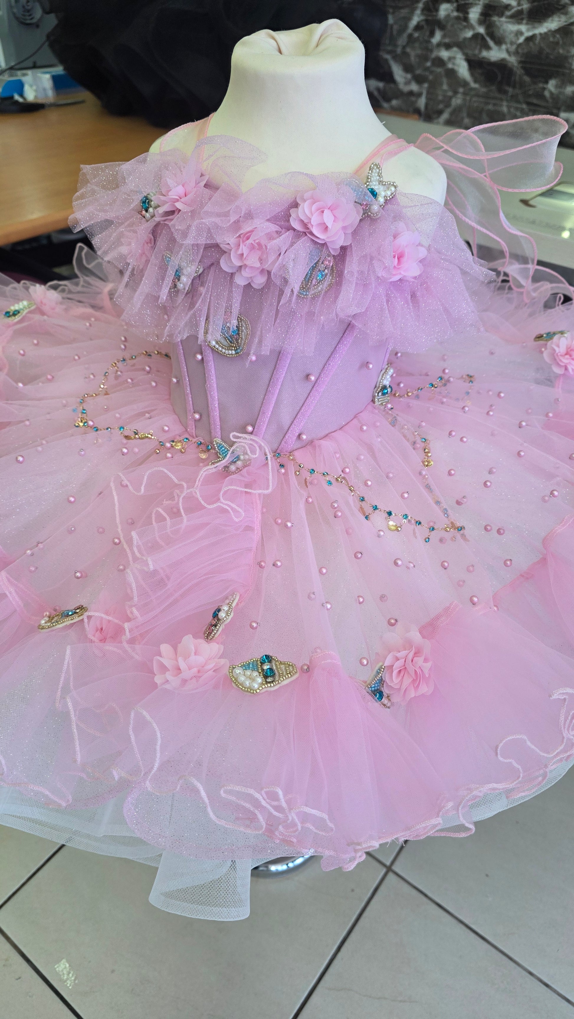 pink and white girls dress on a manequin