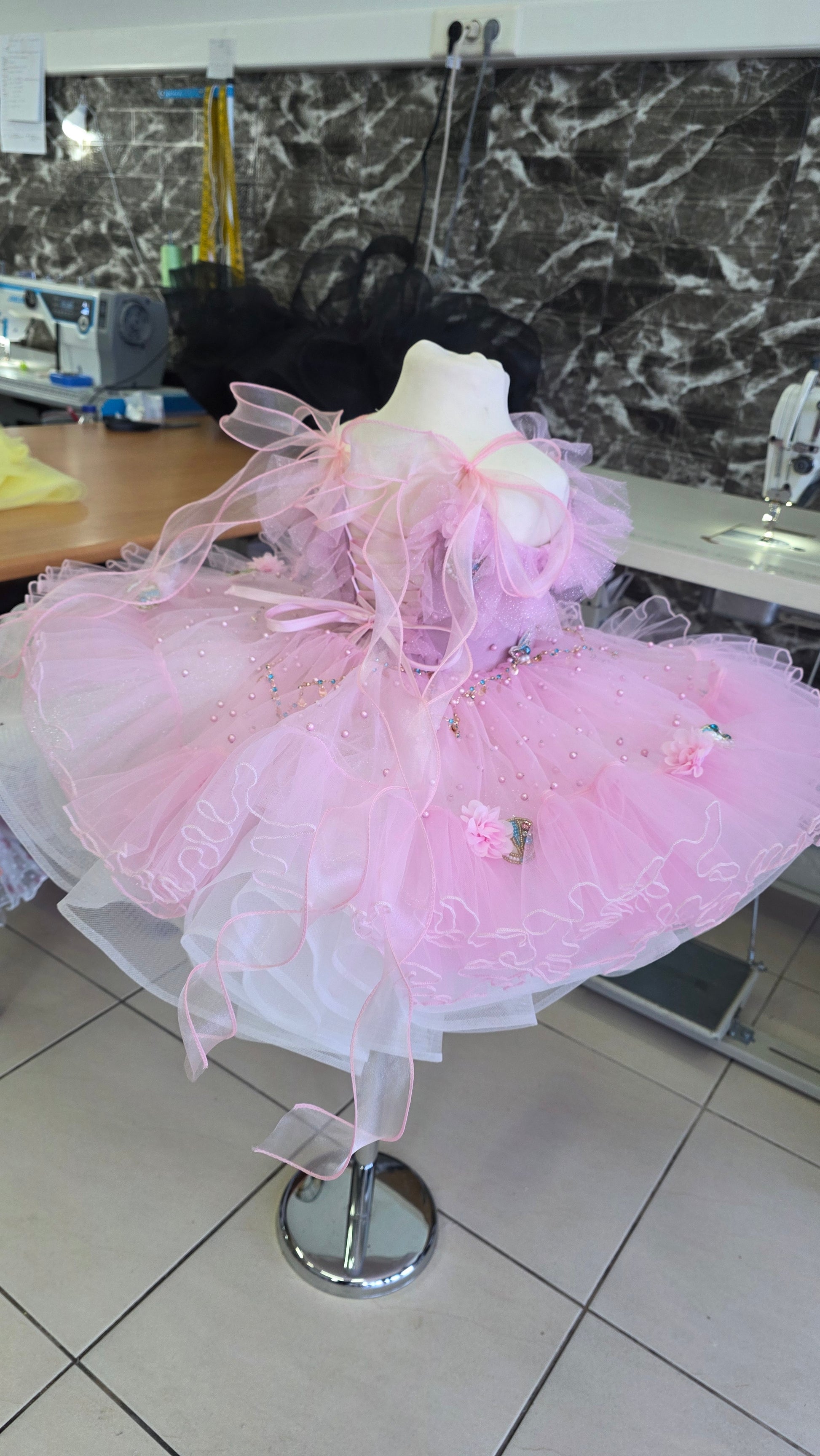 pink and white girls dress on a manequin